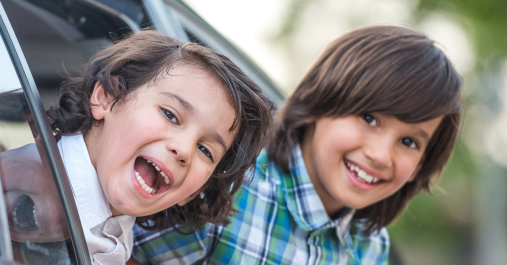 Two boys in car enjoying travel activities for kids