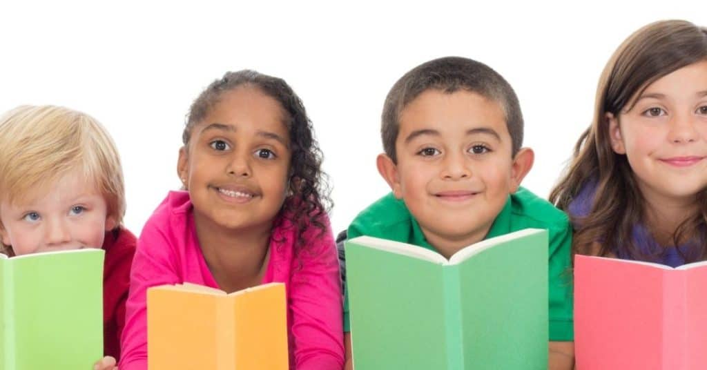 row of children holding their Bible reading plans for kids