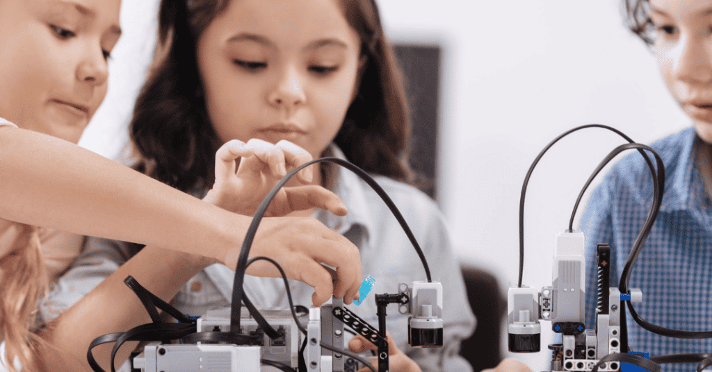 three children building a robot and learning about engineering for kids