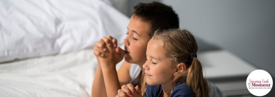 Using the Lord's Prayer for Kids - two kids kneeling beside their bed praying.