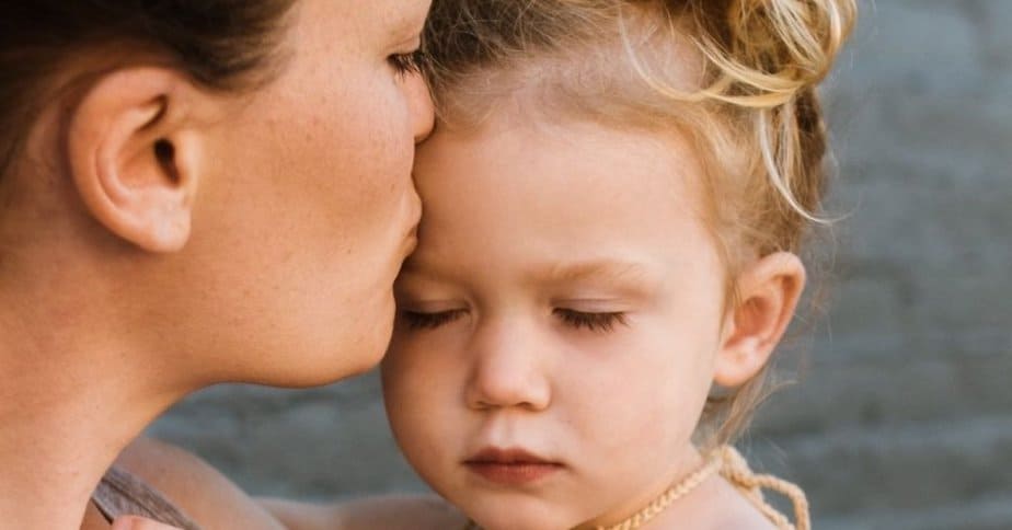 Woman praying simple prayers for mother over her child