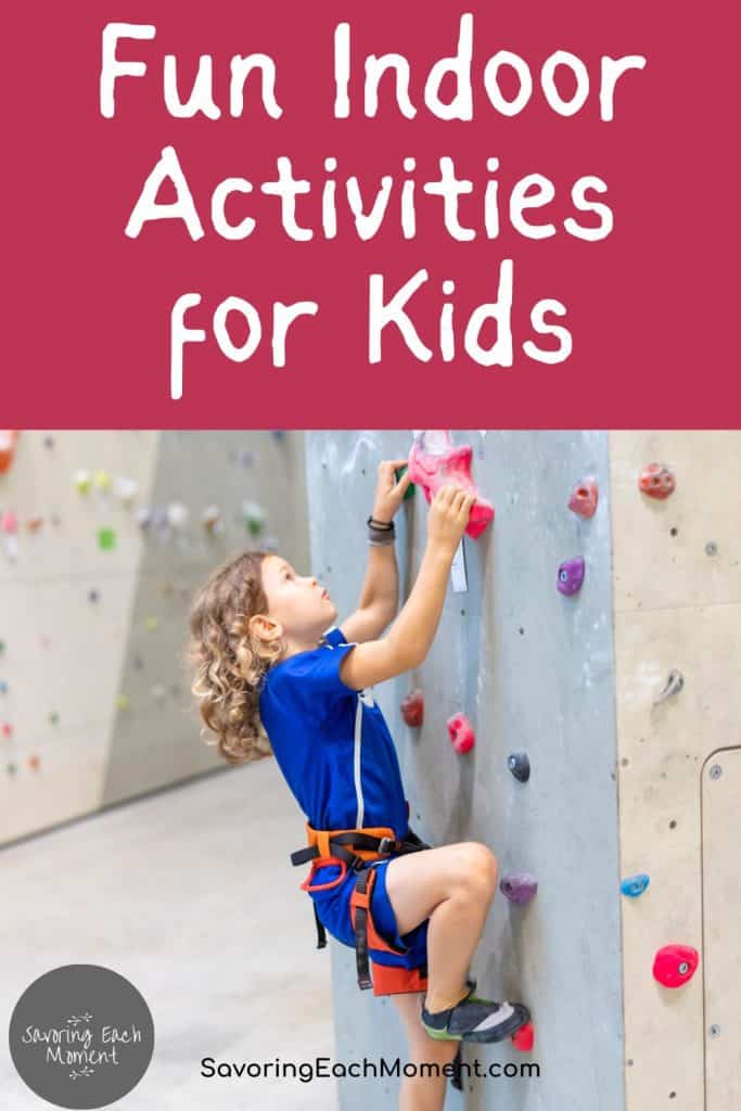 little girl climbing up a climbing wall at the gym