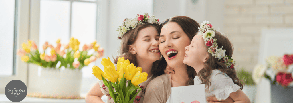 two little girls hugging their mother after their mother's day prayers